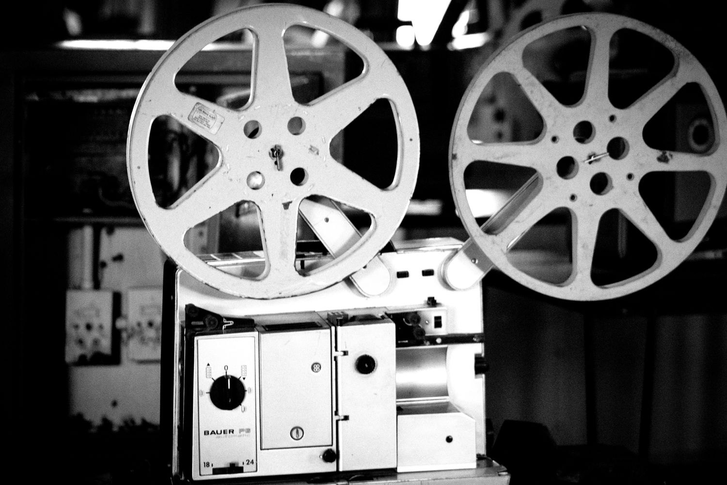 Film projector photographed in black and white.