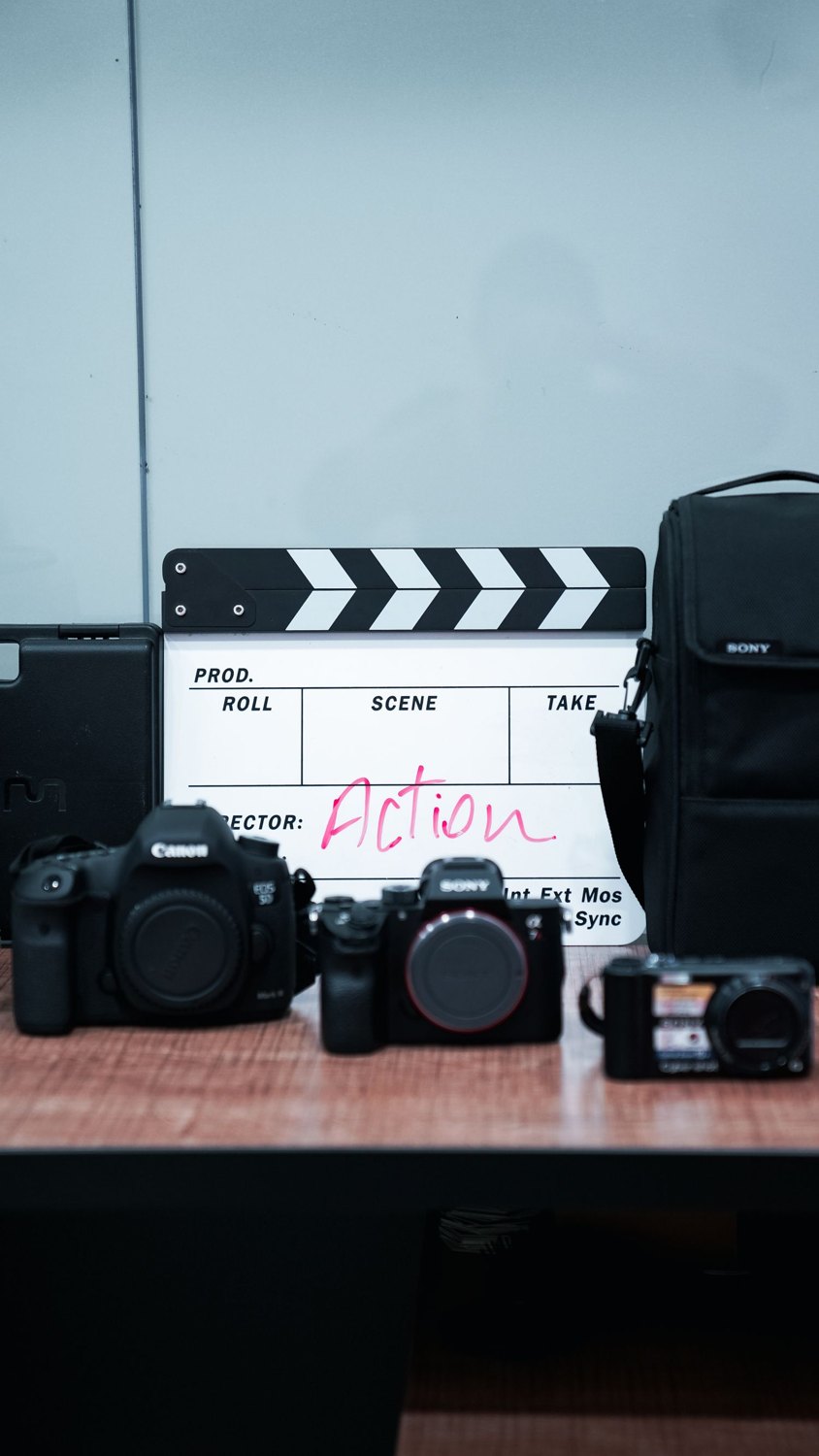 Cameras and a clapperboard used in framing a film.