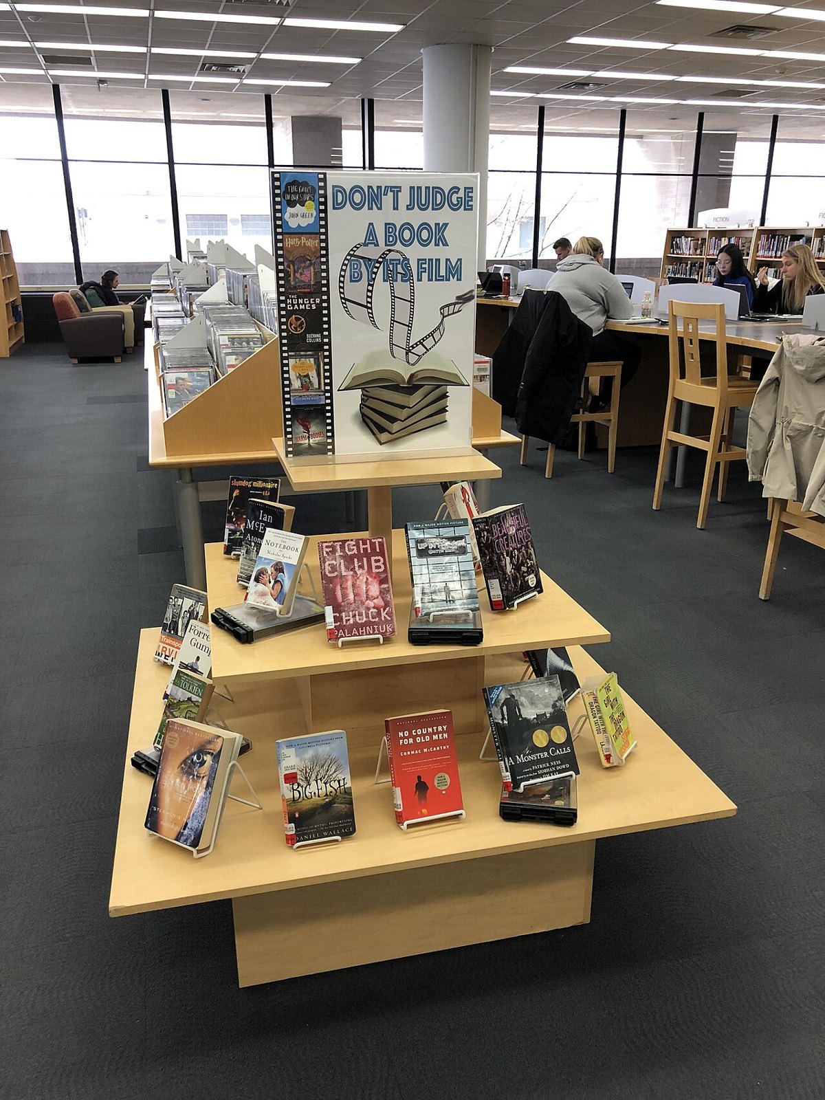 Library display comparing books with their film adaptations.