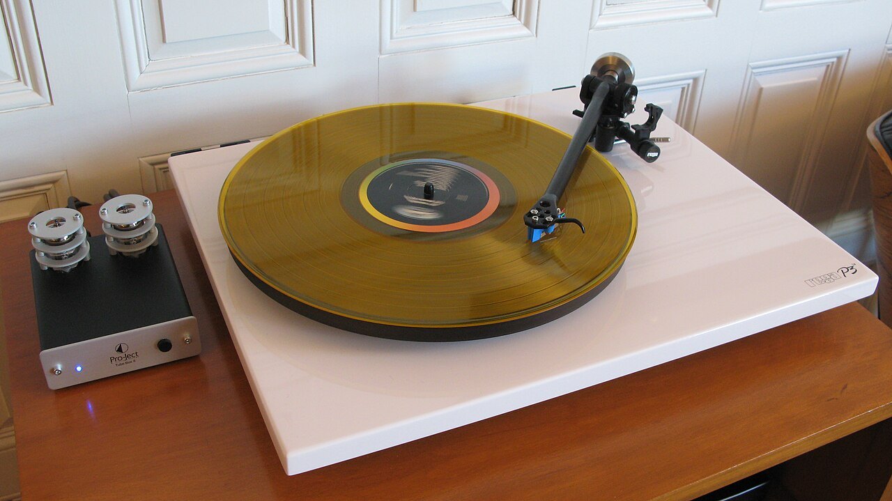 Turntable and preamplifier on a wooden surface.