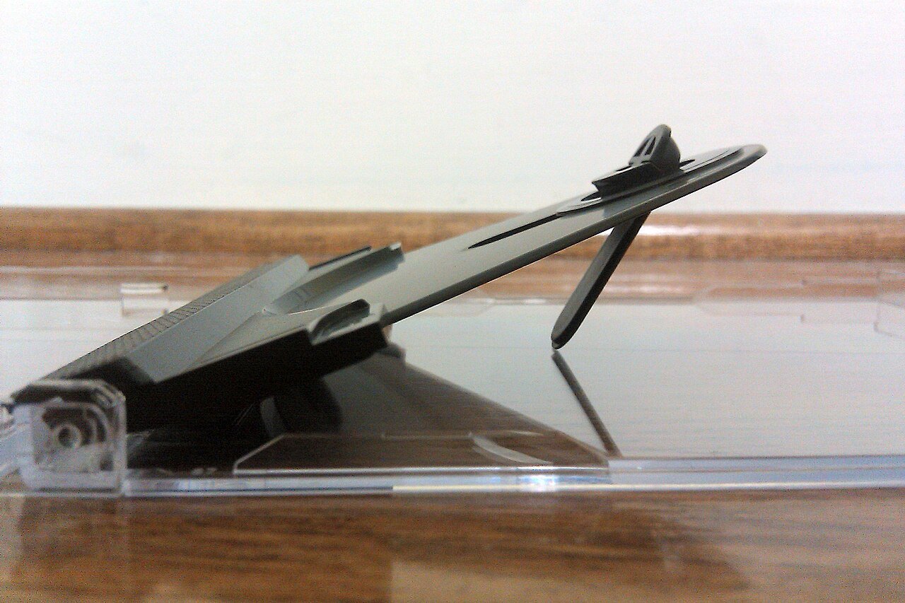 Open CD case with its disc holder raised.