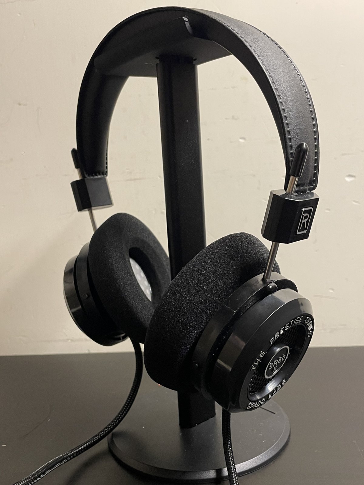 Open-back headphones on a stand.