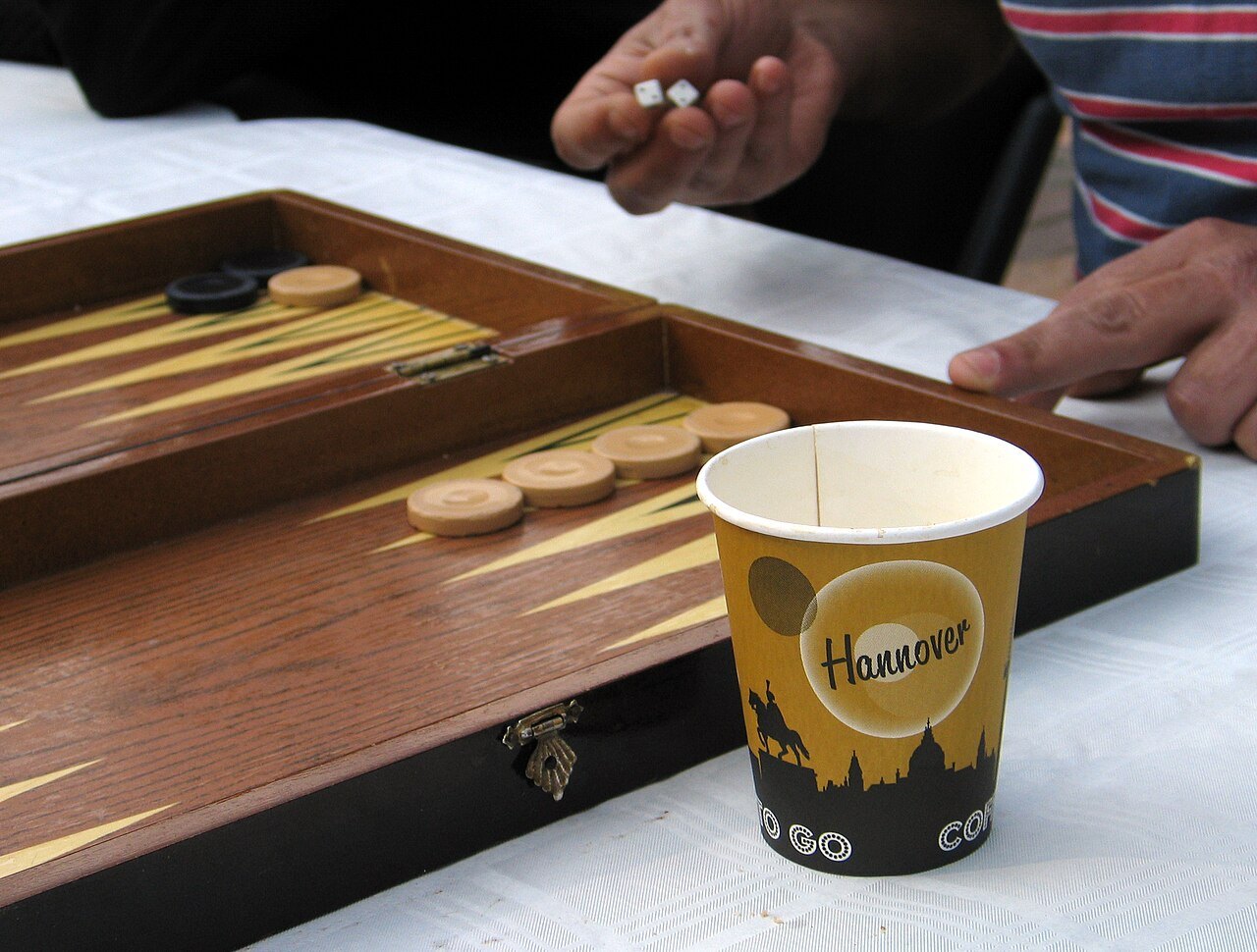 Backgammon pieces and dice during a game.