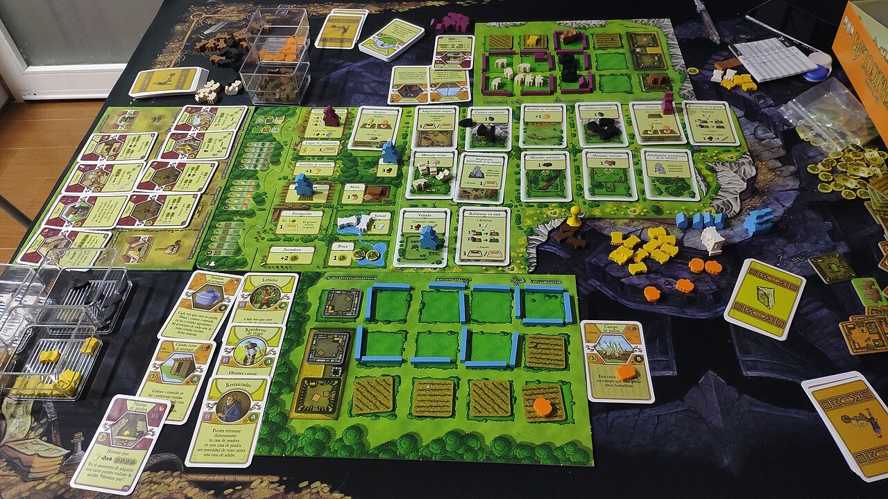 Agricola game laid out with farms, cards and action spaces.
