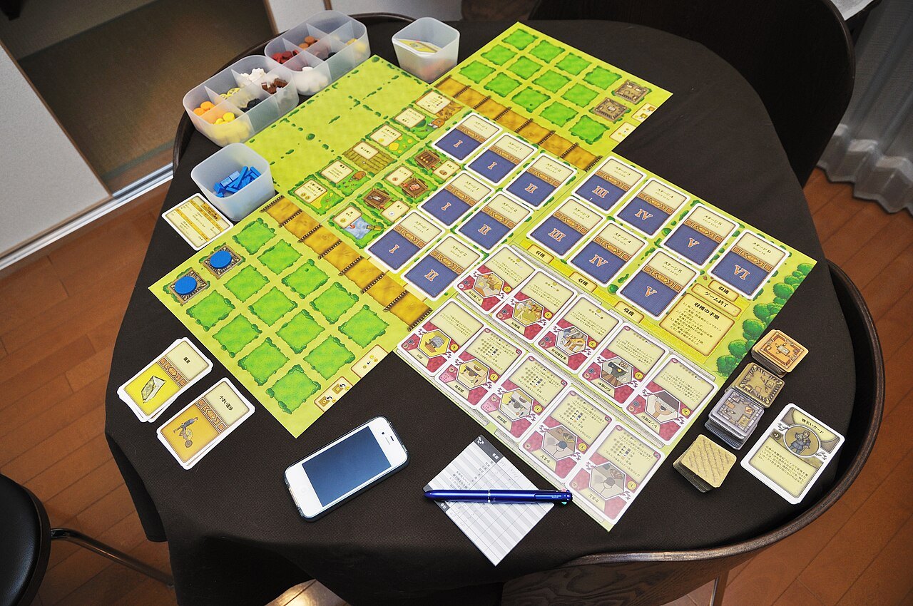 Agricola game components arranged on a small table.