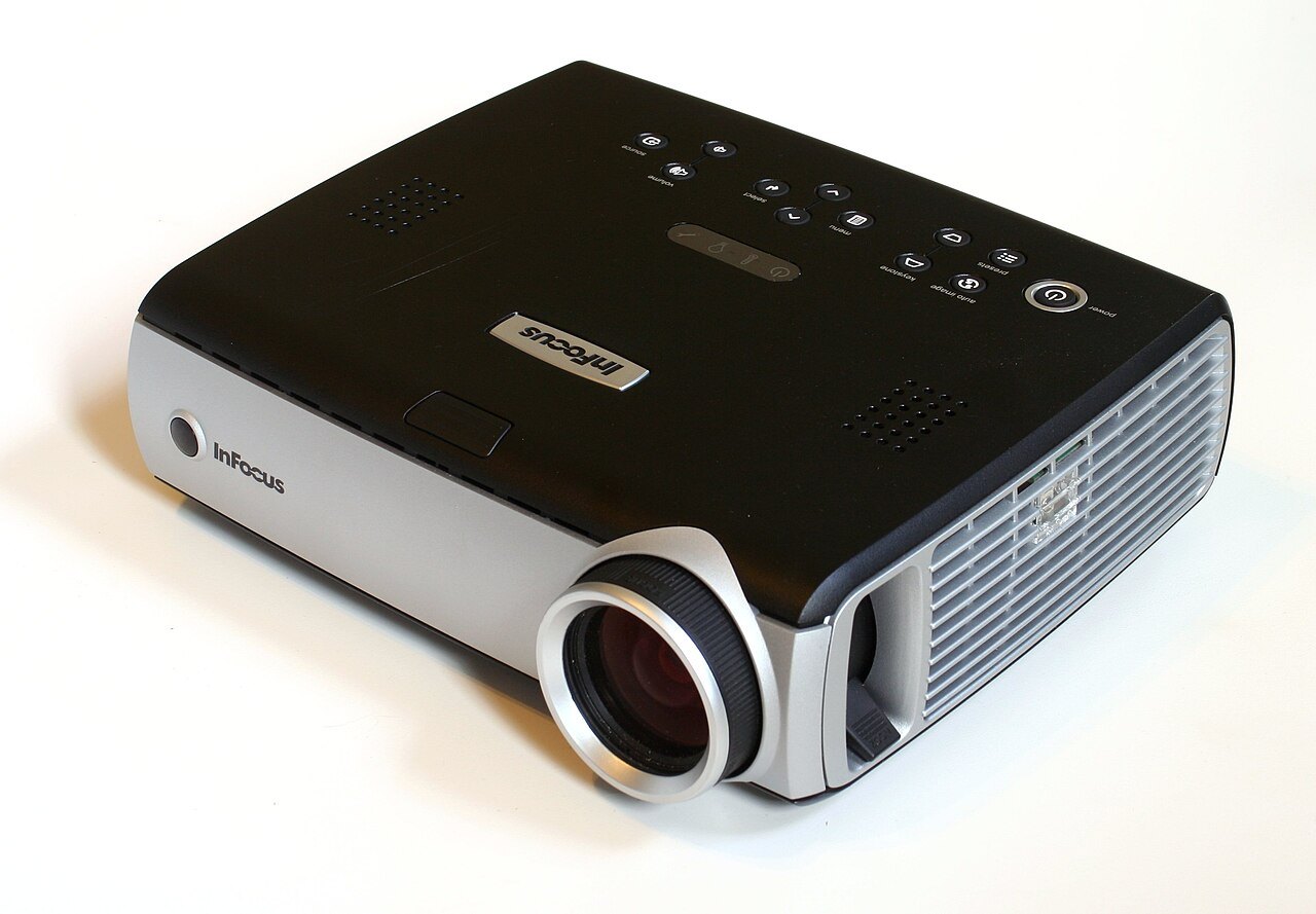 Digital projector with its lens and control panel visible.