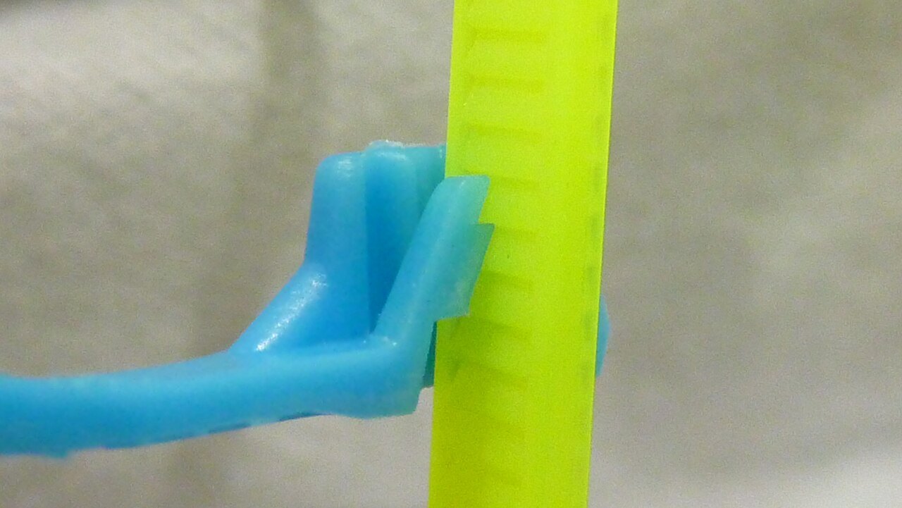 Close-up of a cable tie locking mechanism.