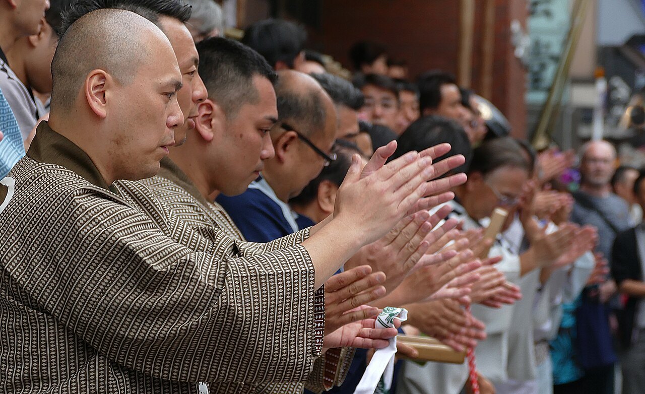 Audience members applauding.