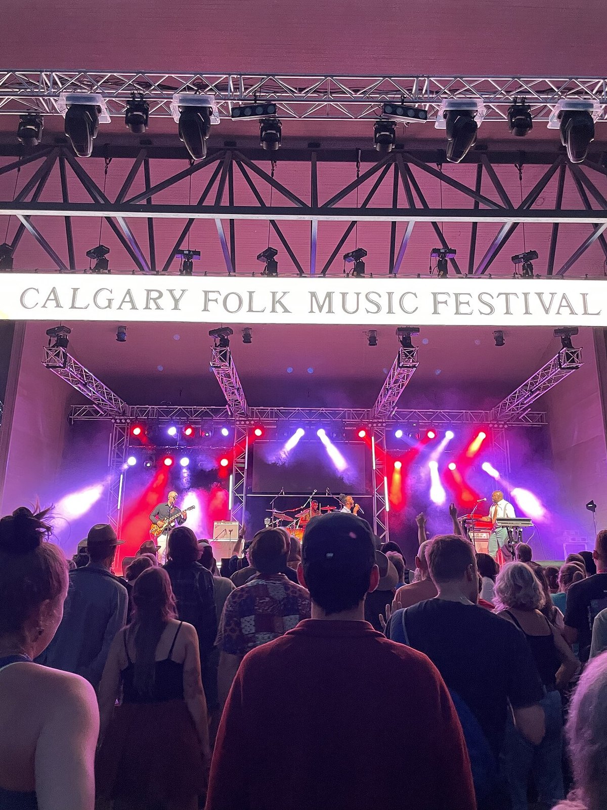 Audience in front of a lit festival stage.