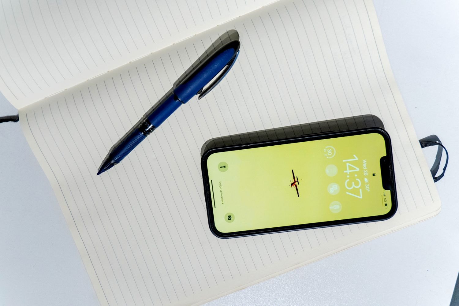 Notebook, pen and smartphone for notes after a visit.