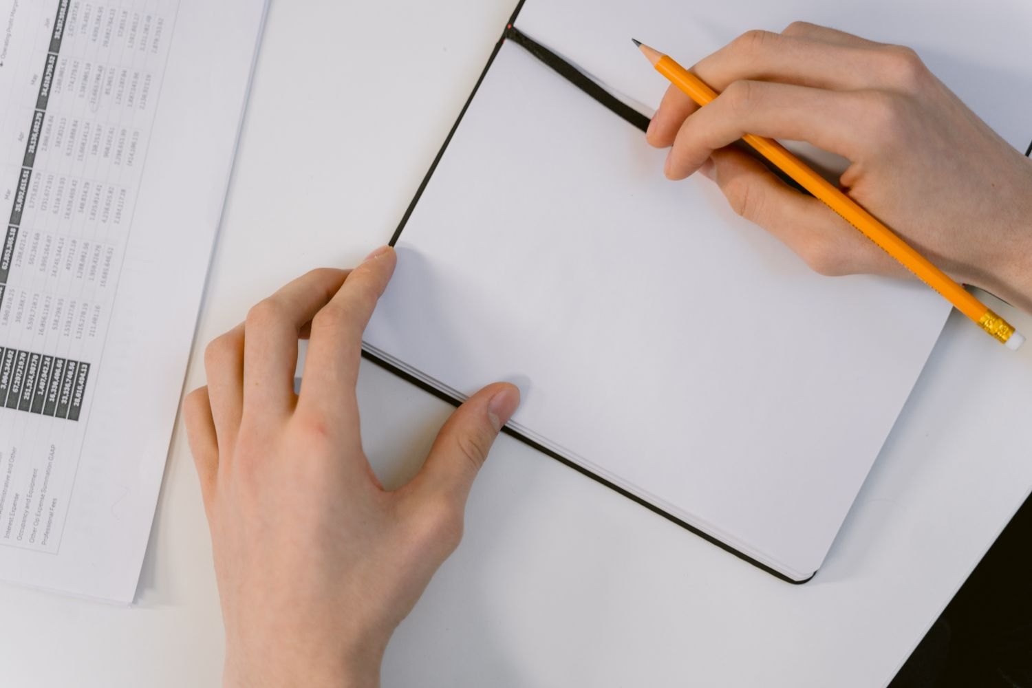 A notebook and pencil for drafting original quiz questions.