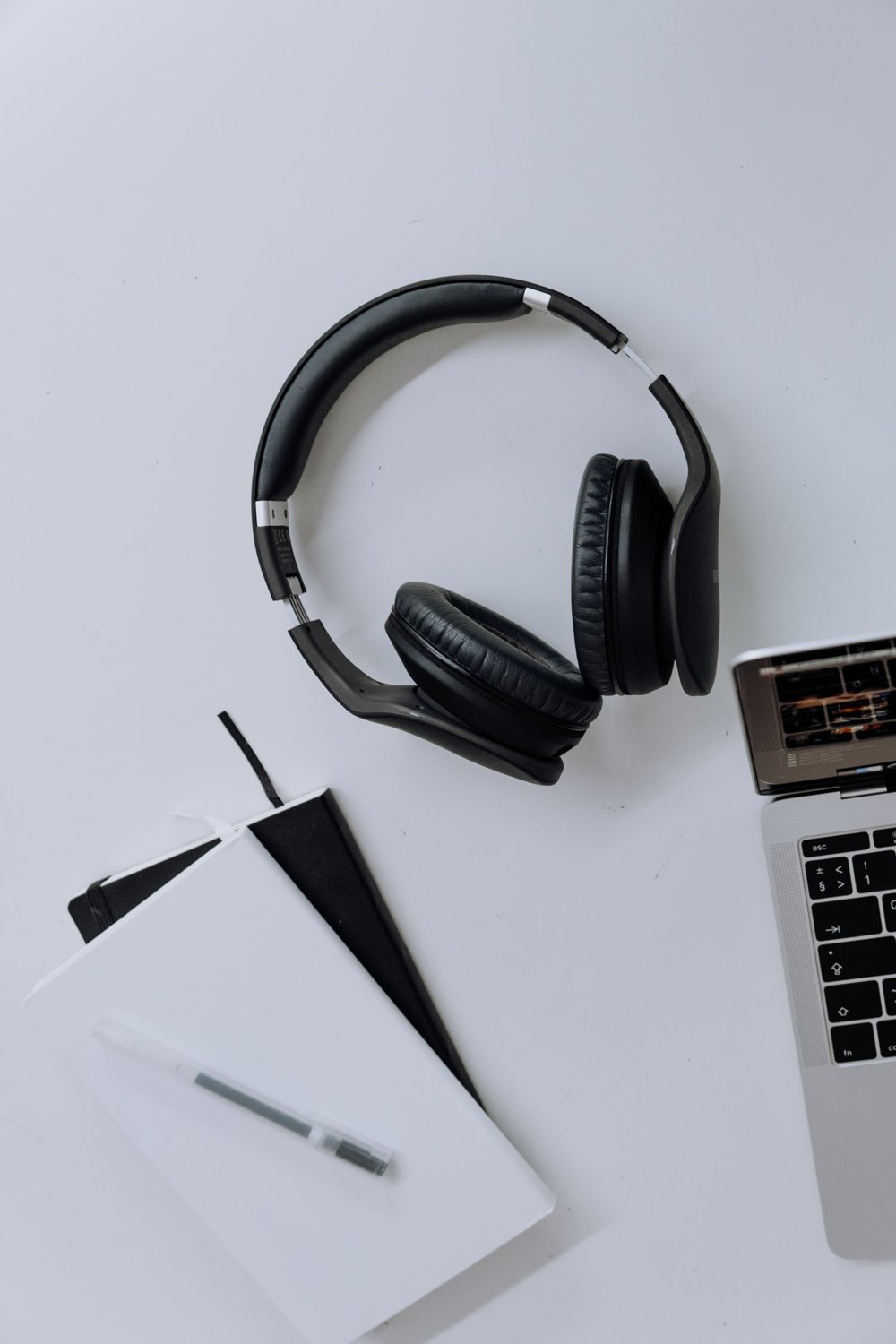 Headphones, a computer and a notebook for preparing listening examples.