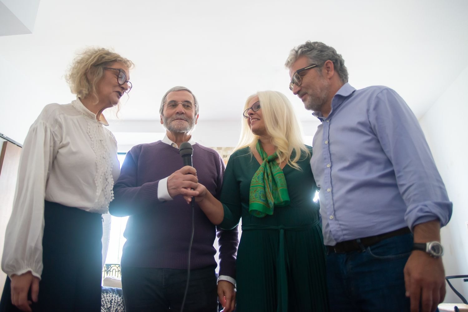 A group sings together using a microphone.