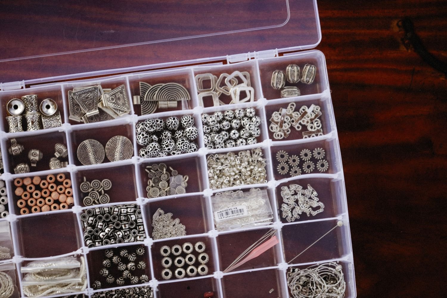 A divided container keeps small craft components sorted and ready.